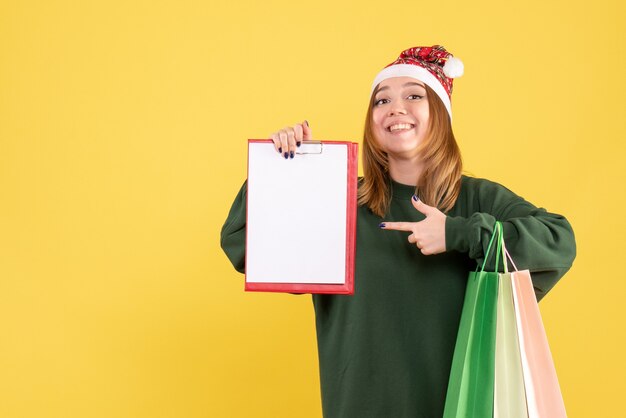 Front view young female with file note and shopping packages