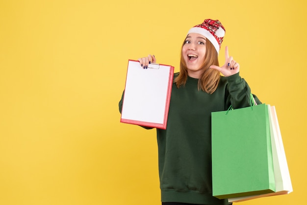 Front view young female with file note and shopping packages