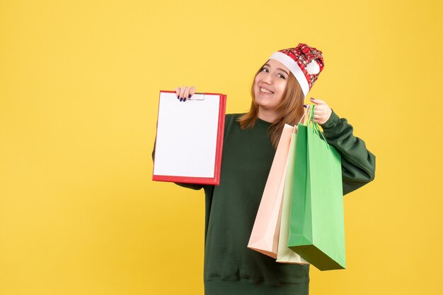 Front view young female with file note and shopping packages