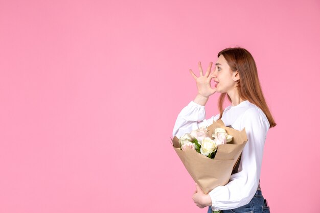 Front view young female with flowers as womens day present on pink background horizontal feminine march love woman sensual date equality rose