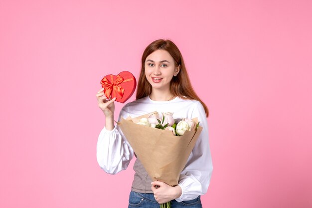 꽃과 분홍색 배경에 여성의 날 선물로 선물 전면보기 젊은 여성 가로 행진 여성 평등 장미 사랑 관능적 인 여성 데이트