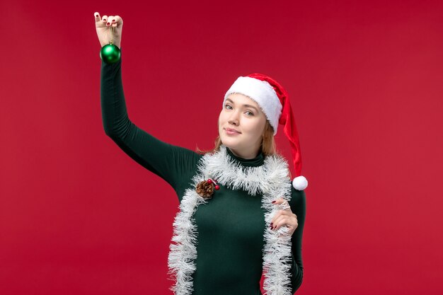 Front view young female with garlands and new year mood on red background