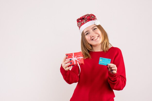 Front view young female with little xmas present and bank card