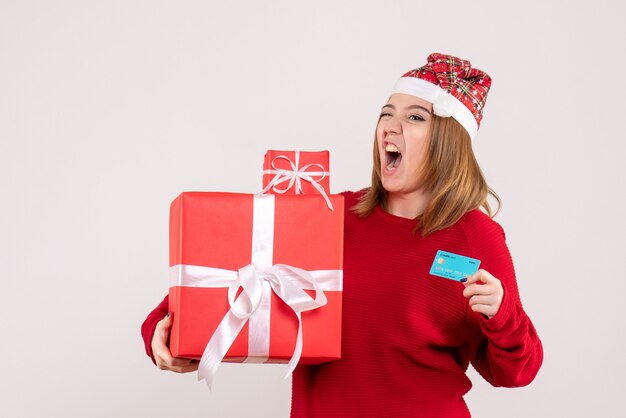 Front view young female with little xmas present and bank card