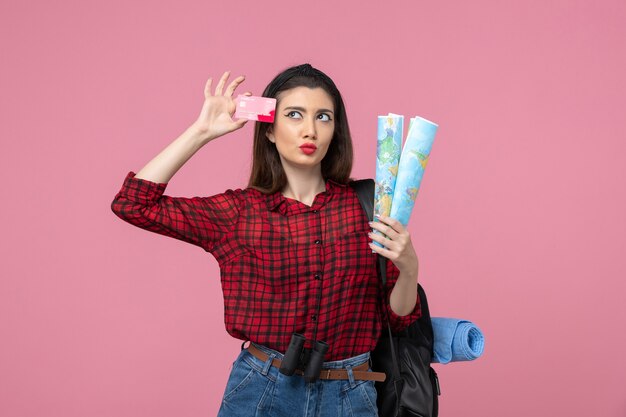 Front view young female with maps and bank card on a pink background color woman human