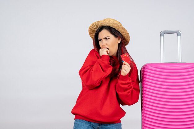 Front view young female with pink bag holding bank card on white wall