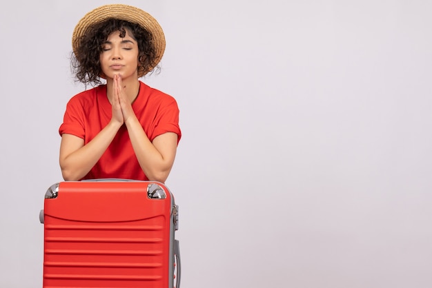 Front view young female with red bag preparing for trip praying on white background vacation sun color voyage rest tourist flight plane