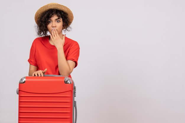 Front view young female with red bag preparing for trip on white background vacation sun color voyage rest tourist flights plane