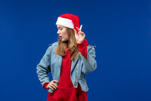 Front view young female with red christmas cap on a blue space