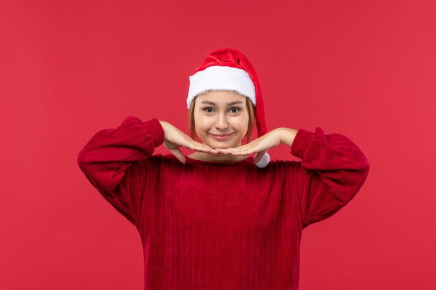 Free photo front view young female with smiling expression, holiday christmas red