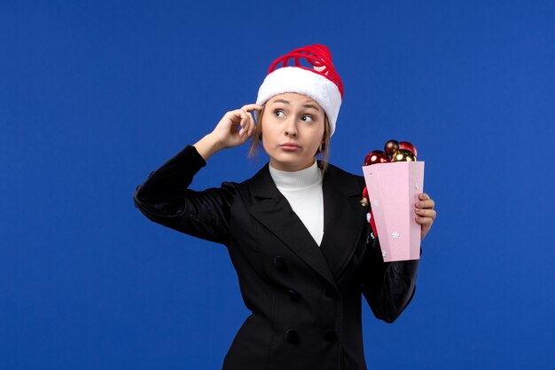 front view young female with tree toys on blue wall emotion new year holiday toy