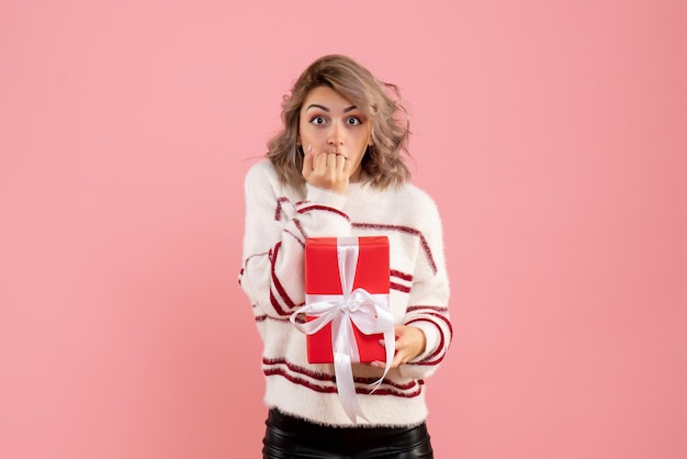 Free photo front view young female with xmas present surprised