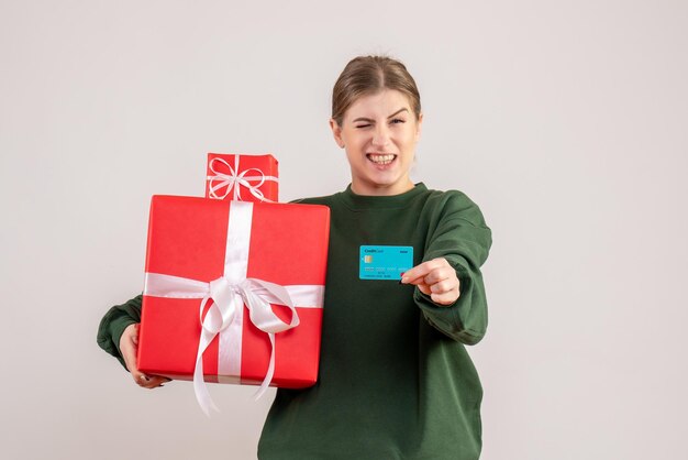 Front view young female with xmas presents and bank card