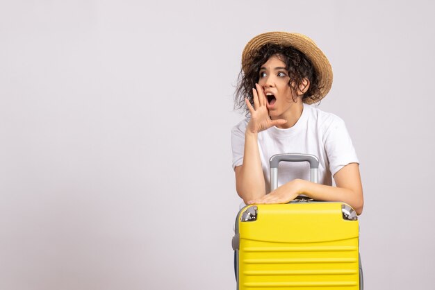 Front view young female with yellow bag preparing for trip on white background sun color voyage vacation plane rest tourist flights