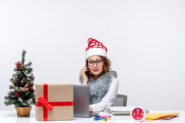 Front view young female at work during holiday days using laptop on white background