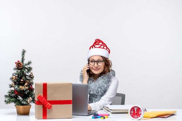 Front view young female at work during holiday days using laptop on white background