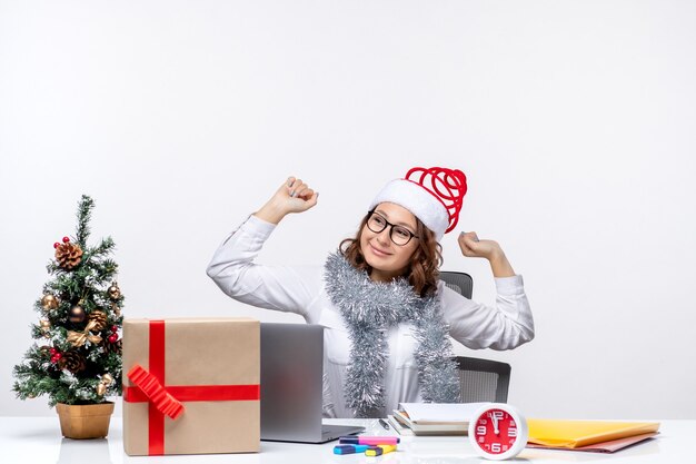 Front view young female worker at working place happily yawning on white background