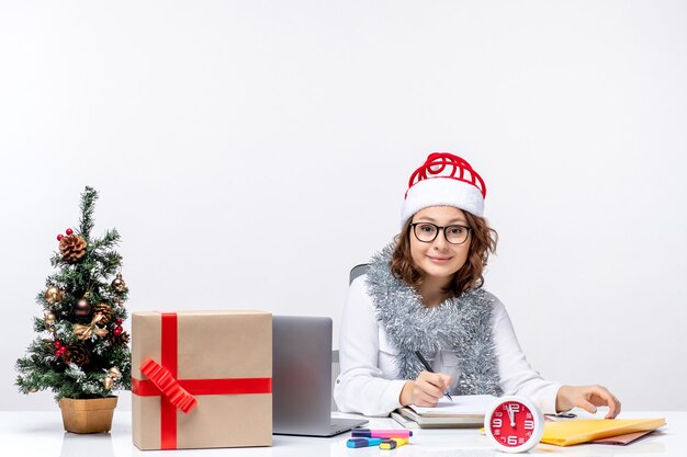 Front view young female at working place writing notes on white background