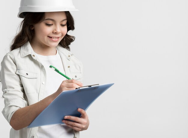 Front view young girl holding clipboard