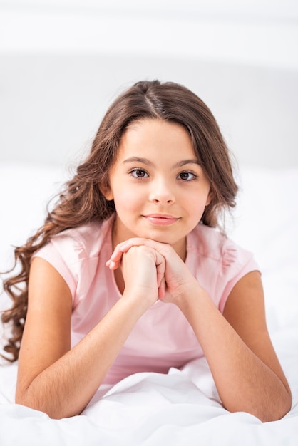 Front view young girl at home staying in bed