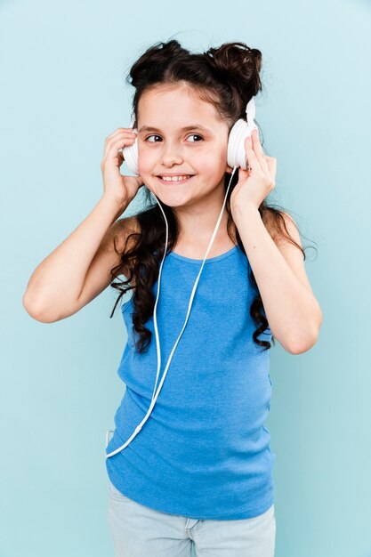 Front view young girl listening music