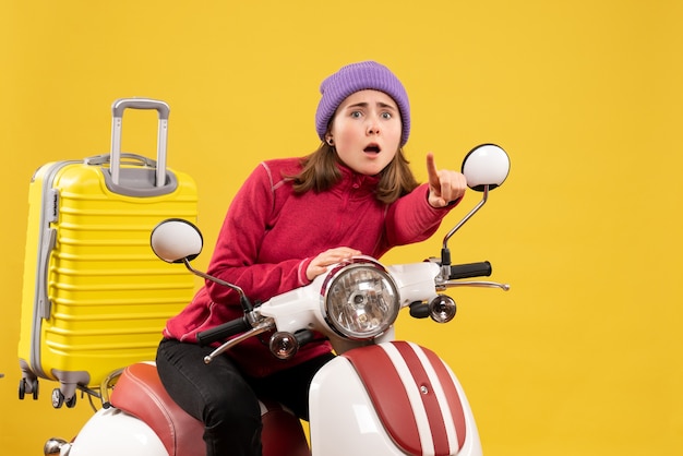 Front view young girl on moped pointing