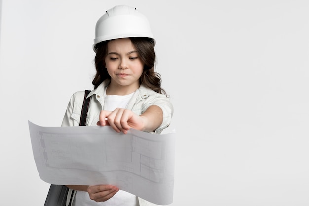 Front view young girl reading construction plan