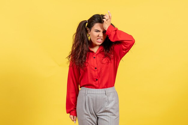 Front view young girl in red blouse with mad face on yellow background color innocence child girl youth kid