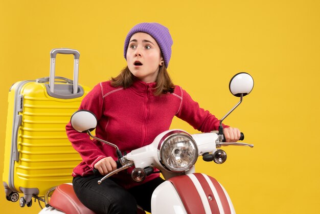 Front view young girl riding a moped