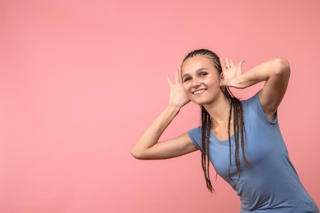 Front view of young girl smiling on pink