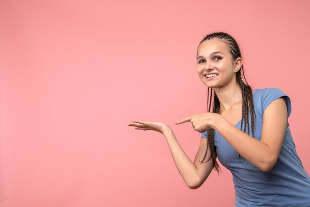 Front view of young girl smiling on pink