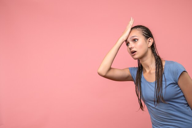 Front view of young girl stressed on pink