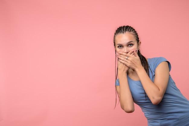 Front view of young girl surprised on pink