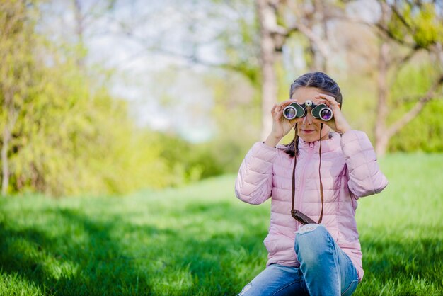 쌍안경으로 어린 소녀의 전면 모습