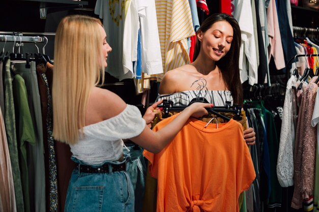 Front view young girlfriends shopping together