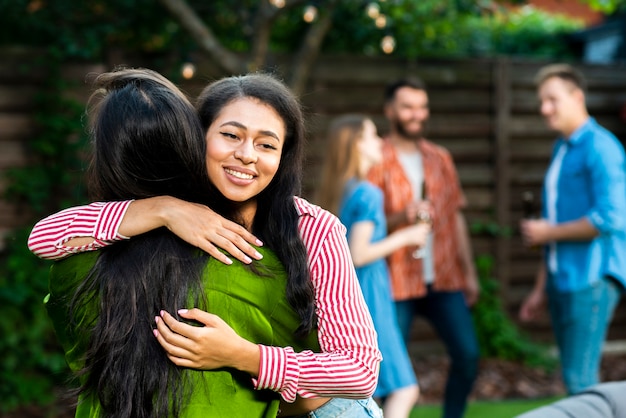 Front view young girls hugging each other