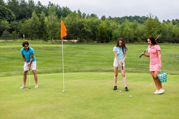 Front view of young golfers playing