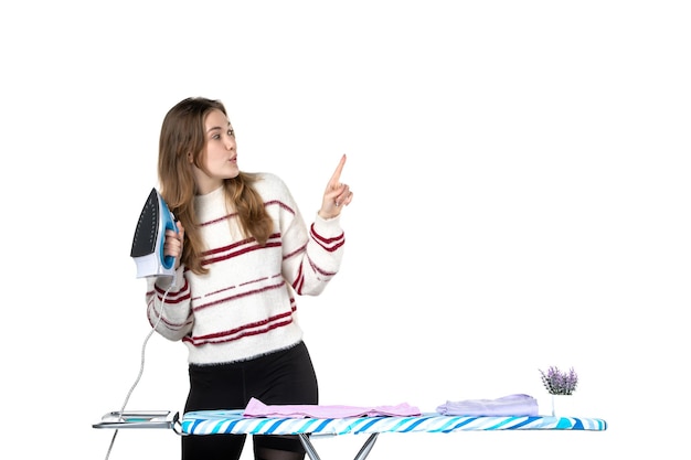 Front view young housewife with ironing board holding iron on a white background clothes laundry home housework woman cleaning work