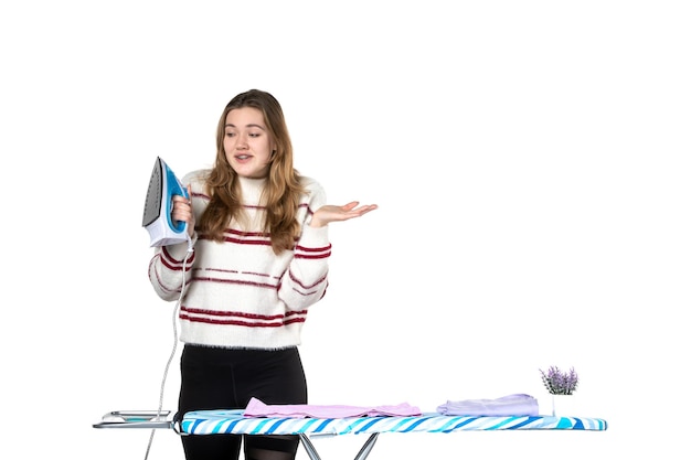 Free photo front view young housewife with ironing board holding iron on white