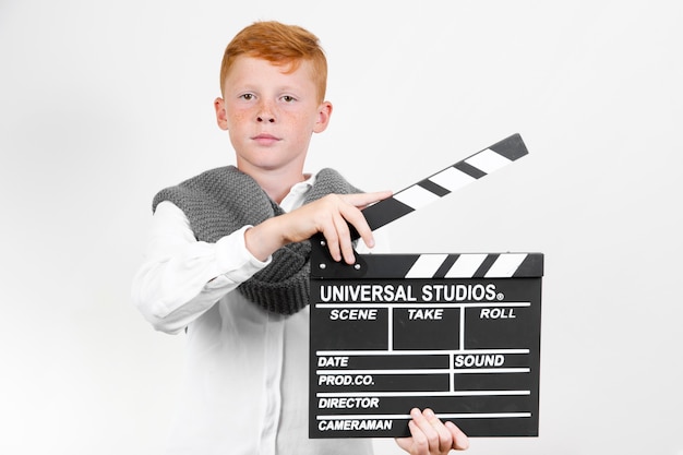 Front view young kid with clapperboard