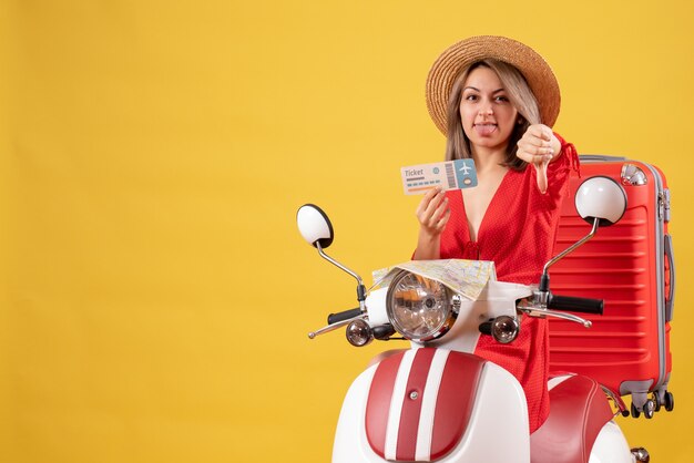 Front view young lady in red dress holding ticket giving thumbs down on moped