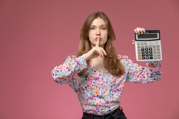 Free photo front view young lady showing silence gesture with her calculator