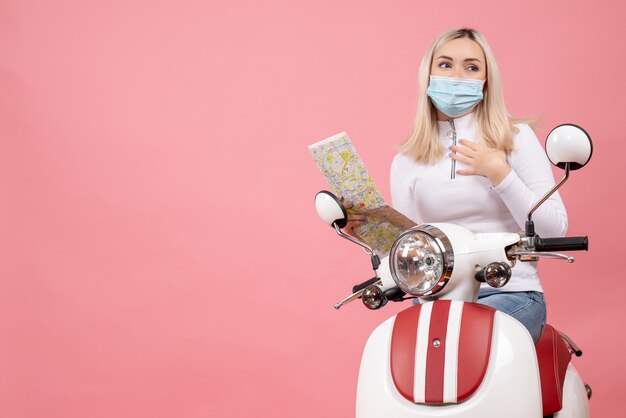 Front view young lady wearing mask holding up map