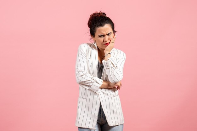 Front view young lady in white jacket with displeased face on pink background fashion woman emotion color feeling lady