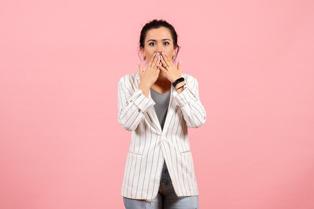 Front view young lady in white jacket with shocked face on pink background fashion woman emotion color feeling lady