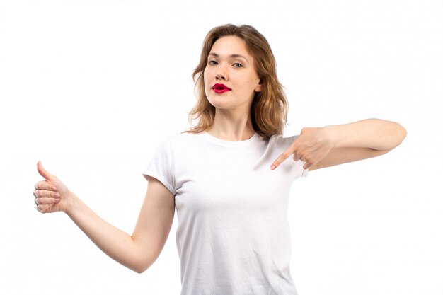 A front view young lady in white shirt and black modern jeans posing on the white