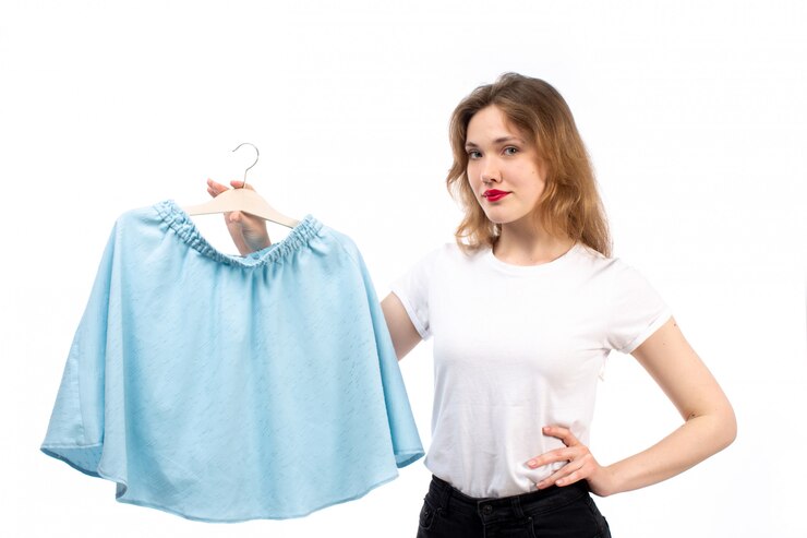 मुफ़्त फोटो a front view young lady in white shirt and black trousers holding blue skirt on the white