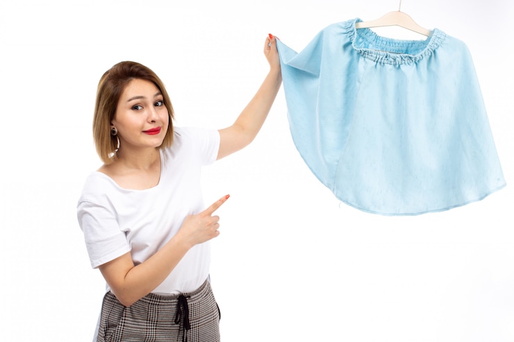 मुफ़्त फोटो a front view young lady in white shirt and light modern trousers holding blue skirt on the white