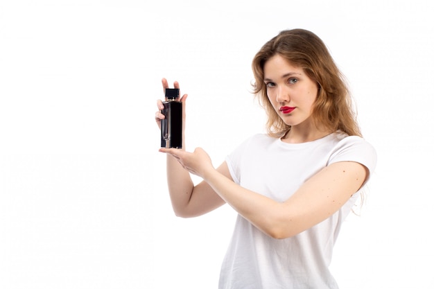 A front view young lady in white t-shirt black shorts holding black tube on the white