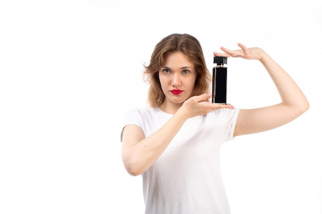 A front view young lady in white t-shirt black shorts holding black tube on the white